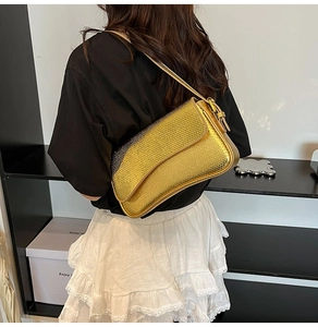 Close-up of golden snakeskin texture and metallic finish on shoulder bag