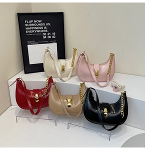 Detail view of crescent underarm bags in five colors with glossy finish and gold chain