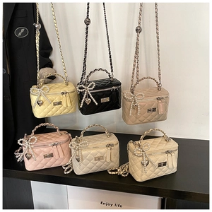 Detailed view of six quilted mini chain bags with pearl bows and heart charms