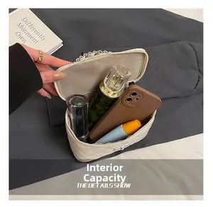 Top view of cream quilted vanity bag showing internal capacity for phone and perfume