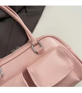 Close-up of pink Boston bag showing silver metal hardware and high-quality PU leather