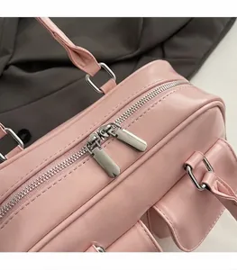 Close-up of smooth two-way silver metal zippers on a premium pink leather handbag