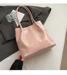 Detail of pink large capacity tote bag on grey blazer with soft glossy PU texture