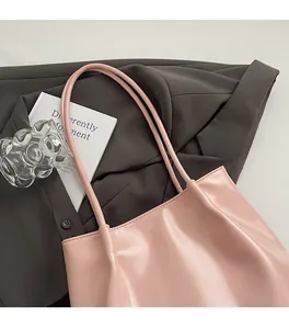 Detail shot of the slender pink PU leather shoulder straps and soft pleated bag texture