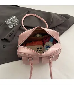 Pink patent leather Boston bag interior showing spacious storage for daily essentials