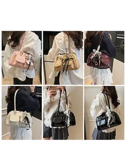 Multiple colors of vintage shoulder bags shown on model with polka dot ribbon details
