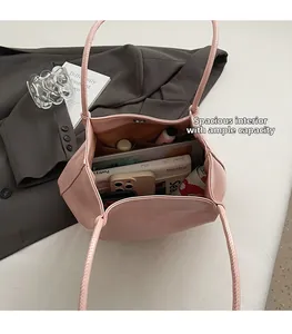 Top view showing large capacity interior of pink faux leather tote bag with essentials