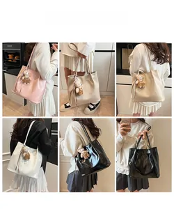 Detail of glossy leather tote bags with cute bear charm in multiple colors