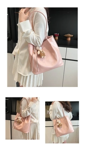 Detail view of pink glossy faux leather tote bag with cute bear and fringe accessories
