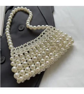 Detail of hand-woven white pearl handbag with rich layers and elegant vintage style