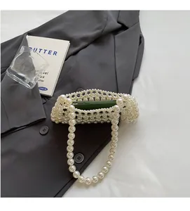 Detailed view of handmade pearl woven handbag showing internal capacity for a smartphone