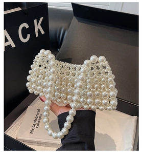 Detail of hand-woven pearl handbag featuring white imitation pearls with elegant texture