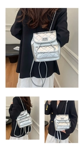 Detail view of silver quilted mini backpack featuring metallic chain and twist lock closure