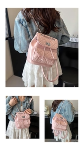 Detailed view of pink quilted PU leather mini backpack with chain strap and twist lock
