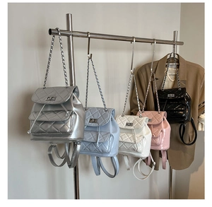 Close-up of quilted chain backpacks in silver, blue, white, pink and black glossy finishes