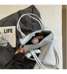 Internal view of a cylinder handbag showing capacity for phone, wallet and cosmetics