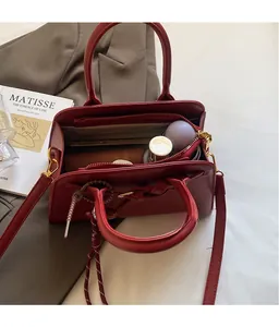 Interior view of red vintage doctor bag showing spacious pockets and zipper compartment