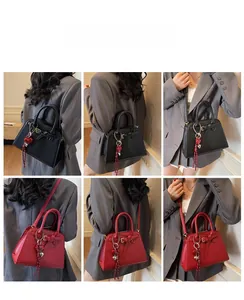 Detail shots of large tote bag in black and red colors with heart charm accessories