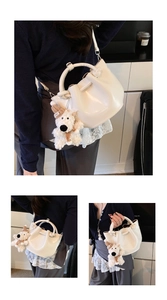 White bucket shoulder bag detail showing premium leather texture and cute plush bear charm.