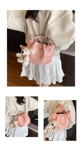 Pink bucket handbag with cute plush bear pendant, stylish knotted handle PU leather shoulder bag