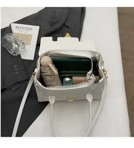 Macro shot of white leather bag interior with multiple compartments and spacious capacity