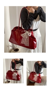 Detail of red glossy leather tote with elegant white lace bow and pearl embellishments