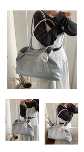 Detail of soft light blue leather tote bag with lace bow pearl charm and metal buckle