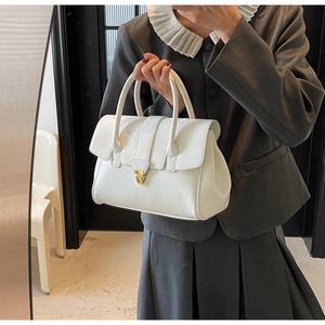 Chic white briefcase handbag with gold lock shown on model for size and style reference