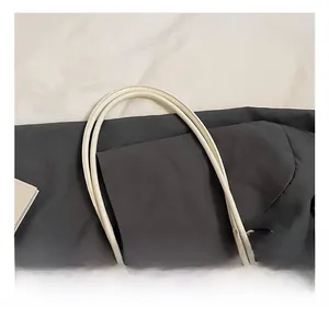 Detail of soft white PU leather tote bag with elegant lace and pearl charms decoration