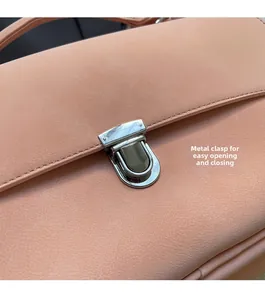 Detail of pink leather handbag showing a silver twist lock and fine stitching texture