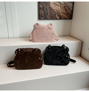 Detailed close-up of cute bear-shaped shoulder bags in pink, brown, and black textures