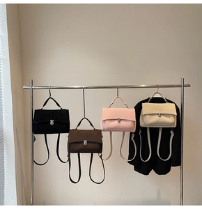 Close-up of four colors of matte satchel bags with silver locks and top handles