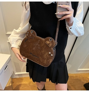 Detail of cute bear-shaped brown leather crossbody bag with Princess embroidery