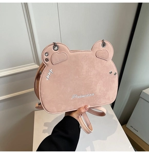 Close-up of pink frosted leather cat-ear bag with heart patches and Princess embroidery