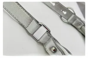 Close-up of metallic silver leather strap with vintage crackle texture and chrome buckle