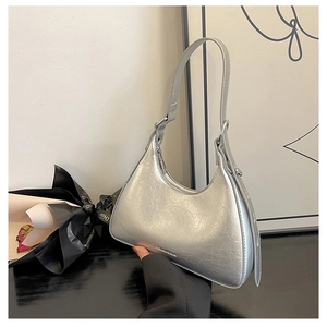 Detail showing the silver cracked textured faux leather and metal letter on the underarm bag