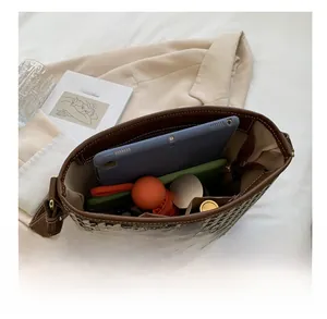 Interior view of houndstooth bucket bag showing capacity for tablet, umbrella, and makeup