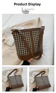 Detail of houndstooth patchwork bucket bag with brown leather base and adjustable strap