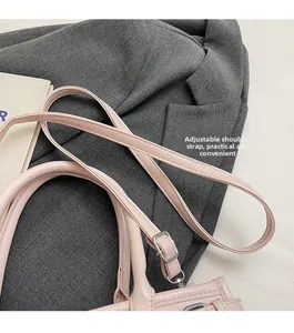 Detail of adjustable shoulder strap and dual handles on a pink minimalist tote bag