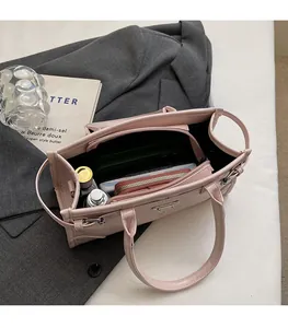 Top view of pink tote bag showing large internal capacity with wallet and phone