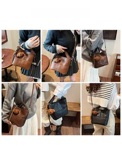 Lifestyle views of brown and black bucket bags with bear charms and shoulder straps