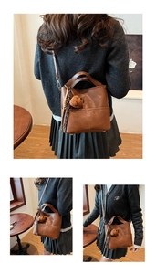 Brown bucket bag detail showing soft matte texture and cute plush bear accessory