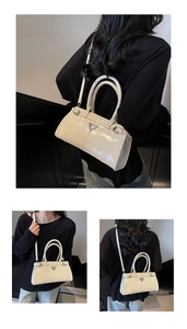 Detailed views of a beige glossy mini Boston bag with silver triangle logo and slim handles