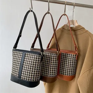 Chic houndstooth bucket bag set in black, dark brown, and caramel with leather straps