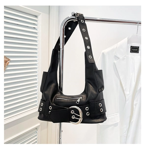 Detail view of black hobo bag with punk-style silver metal eyelets and buckle details