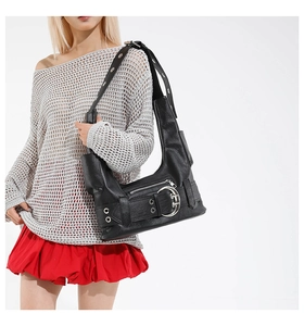 Close-up of black Y2K punk style shoulder bag with silver metal buckles and eyelet details