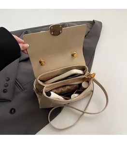 Spacious interior of stylish cream crossbody bag showing capacity for phone and cosmetics
