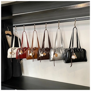 Detailed row of six leather bowling bags in various colors with baseball pendants