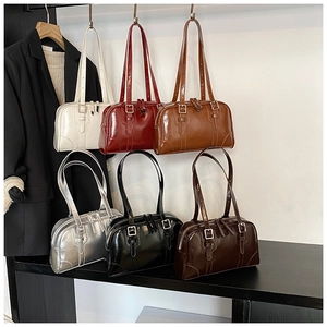 Collection of shiny faux leather bowling bags in assorted colors with metal buckles