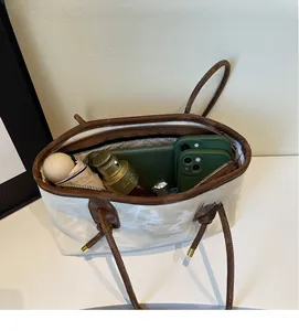 Spacious interior of a canvas tote bag showing storage for cosmetics and daily items